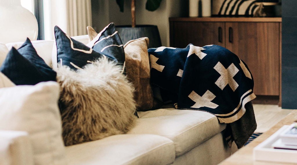 helvetia throw blanket by seek & swoon with taupe crosses and black background